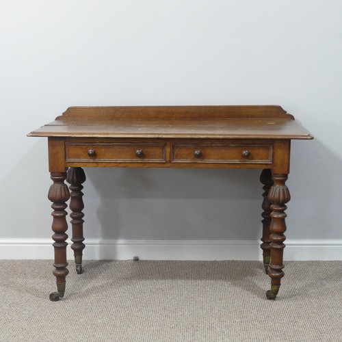 461 - An antique carved oak Writing table, with gallery back above two frieze drawers, all raised on turne... 