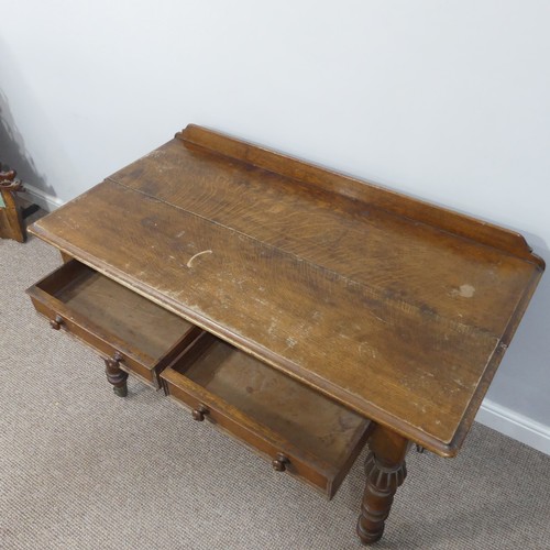 461 - An antique carved oak Writing table, with gallery back above two frieze drawers, all raised on turne... 