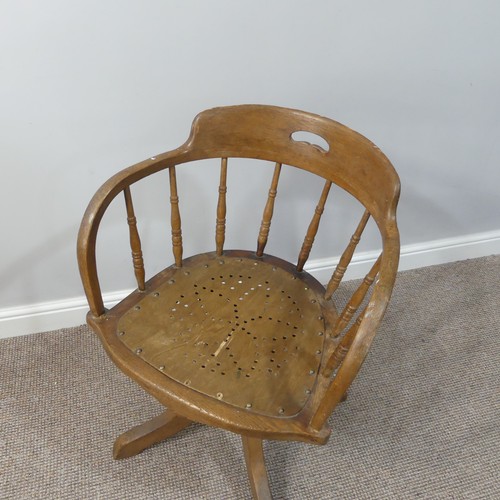 473 - A late 19thC/ early 20thC oak bow-arm swivel Desk Chair, the mechanism stamped Patt Apr 1895, damage... 