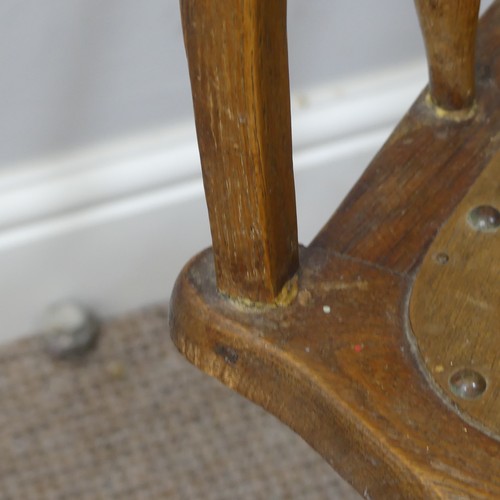 473 - A late 19thC/ early 20thC oak bow-arm swivel Desk Chair, the mechanism stamped Patt Apr 1895, damage... 