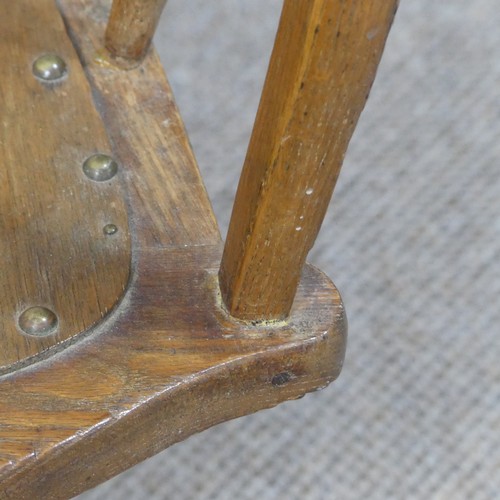 473 - A late 19thC/ early 20thC oak bow-arm swivel Desk Chair, the mechanism stamped Patt Apr 1895, damage... 