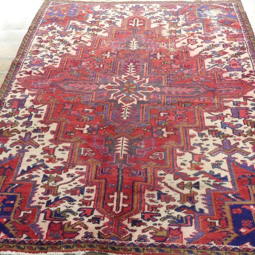 602 - Tribal Rugs; an old red ground Kazak wool on cotton carpet, pile very worn, 240cm x 200cm... 