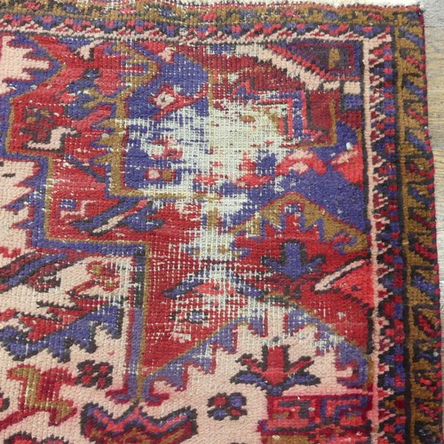 602 - Tribal Rugs; an old red ground Kazak wool on cotton carpet, pile very worn, 240cm x 200cm... 