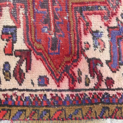 602 - Tribal Rugs; an old red ground Kazak wool on cotton carpet, pile very worn, 240cm x 200cm... 