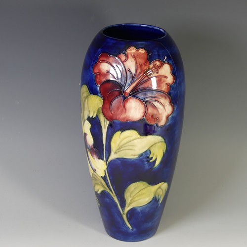 45 - A Walter Moorcroft 'Hibiscus' pattern Baluster Vase, tube lined decoration on cobalt blue ground, wi... 