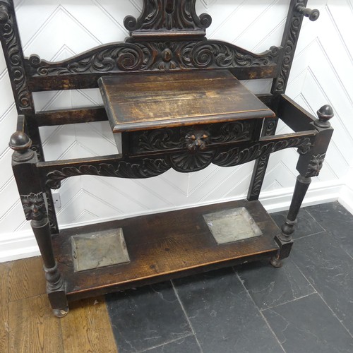 476 - A Victorian carved oak Jacobean Revival Hallstand, with shield shape mirror plate, single frieze dra... 