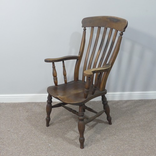 477 - A Victorian ash and elm open arm Windsor Chair, with slat back and solid seat on turned supports, W ... 