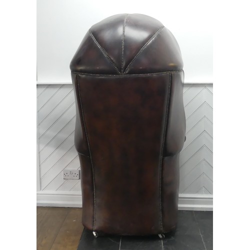 481 - A Georgian style button-back leatherette Hall Porter's Chair, with arched top and rounded seat, on c... 