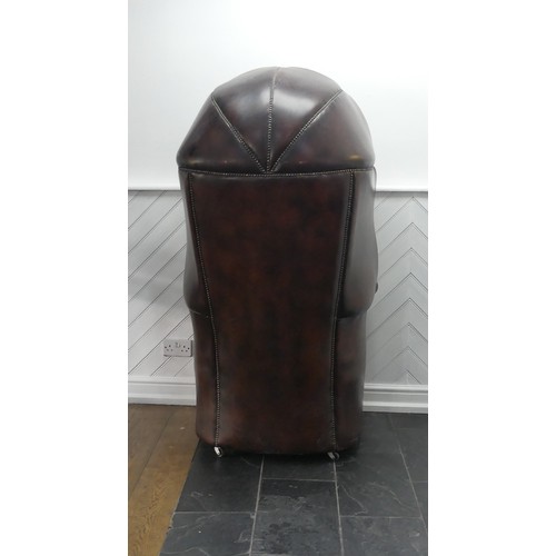 481 - A Georgian style button-back leatherette Hall Porter's Chair, with arched top and rounded seat, on c... 