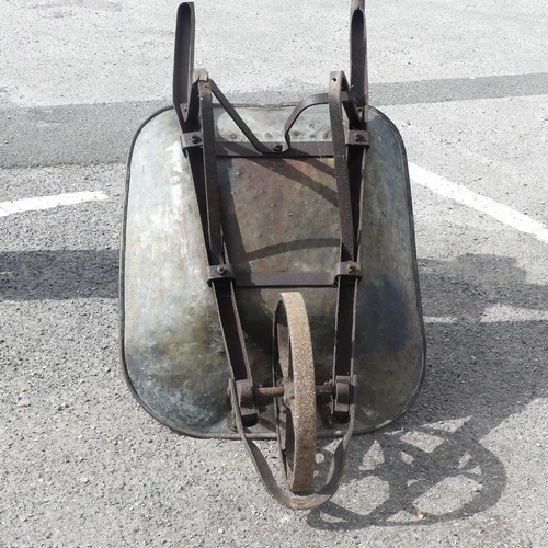 483 - An antique rustic metal Wheelbarrow, with spoked wheel and two handles, rusted and weathered, 155cm ... 