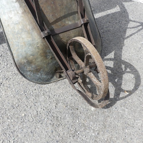 483 - An antique rustic metal Wheelbarrow, with spoked wheel and two handles, rusted and weathered, 155cm ... 