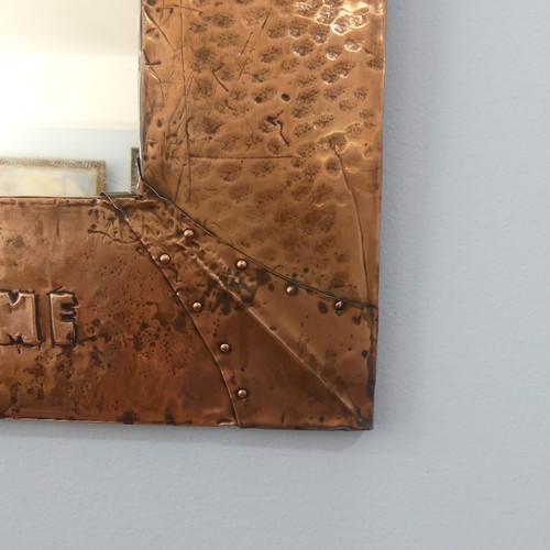 491 - An Arts and Crafts copper framed rectangular Wall Mirror, hammered and riveted surround with motto '... 