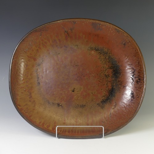 A Michael Leach studio pottery Dish, with iron red mottled ground, with impressed marks for Yelland Pottery verso, 21cm x
