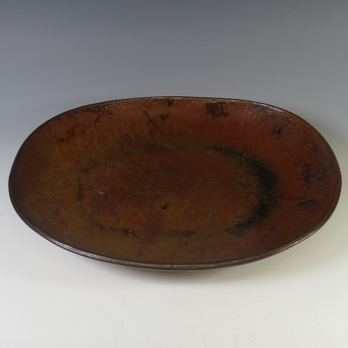 75 - A Michael Leach studio pottery Dish, with iron red mottled ground, with impressed marks for Yelland ... 