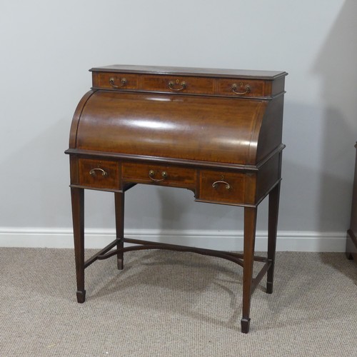 498 - An Edwardian inlaid mahogany roll-top Bureau, having a three drawer section top over roll top openin... 