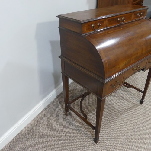 498 - An Edwardian inlaid mahogany roll-top Bureau, having a three drawer section top over roll top openin... 