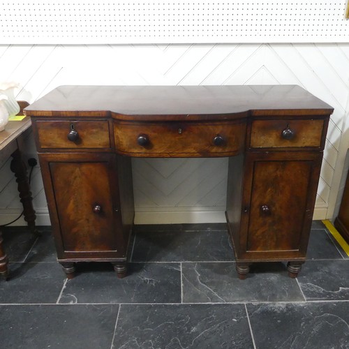 516 - A Georgian mahogany pedestal Sideboard, the shaped top above three frieze drawers and two cupboards,... 