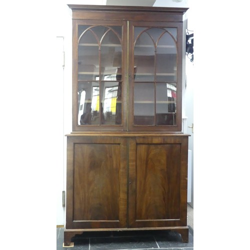 517 - A George III mahogany astragal glazed Bookcase, the moulded cornice above two glazed doors, enclosin... 