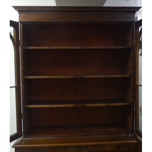 517 - A George III mahogany astragal glazed Bookcase, the moulded cornice above two glazed doors, enclosin... 