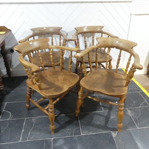 534 - A set of eight elm and beech Smokers Bow Chairs, with turned spindles, shaped seat and H stretcher (... 