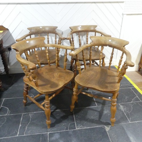 534 - A set of eight elm and beech Smokers Bow Chairs, with turned spindles, shaped seat and H stretcher (... 