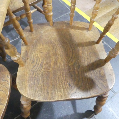 534 - A set of eight elm and beech Smokers Bow Chairs, with turned spindles, shaped seat and H stretcher (... 