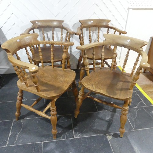 534 - A set of eight elm and beech Smokers Bow Chairs, with turned spindles, shaped seat and H stretcher (... 