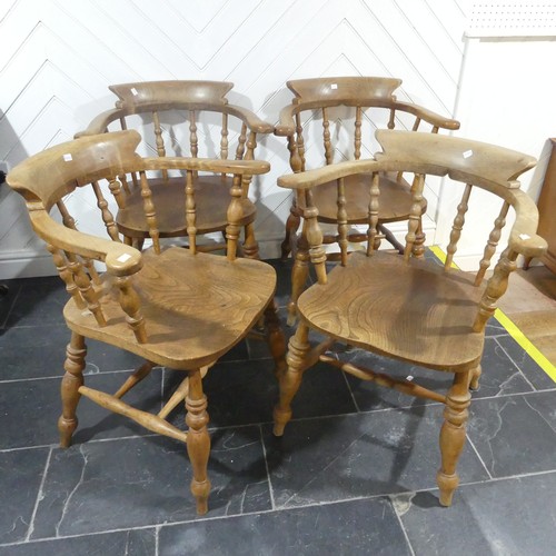 534 - A set of eight elm and beech Smokers Bow Chairs, with turned spindles, shaped seat and H stretcher (... 