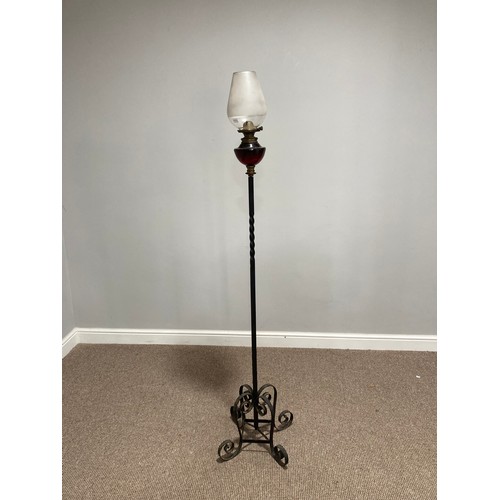 362 - A wrought iron and red glass standard Lamp Stand with Oil Lamp, the red glass lamp with opaque glass... 