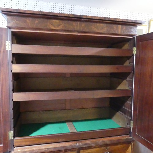 536 - A Georgian mahogany Linen Press, the doors opening to reveal fitted slides, upon two short and two l... 