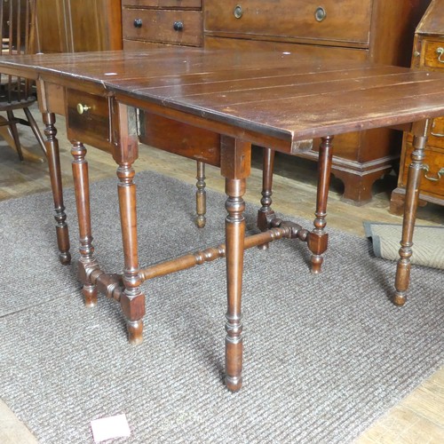 540 - A Georgian mahogany drop-leaf Table, with double frieze drawer, raised on turned legs, one leg broke... 