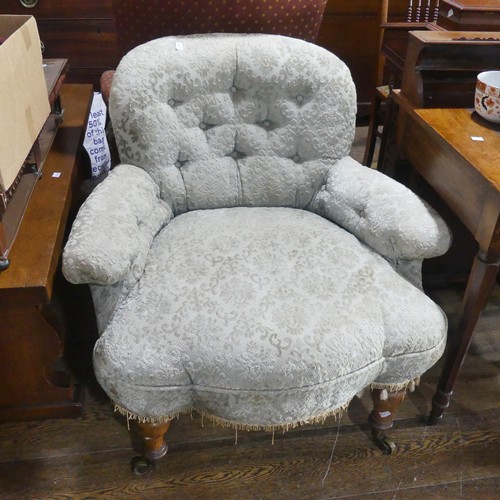 523 - A Victorian upholstered Armchair, with turned feet and castors, fading to fabric, W 82cm x D 84cm x ... 