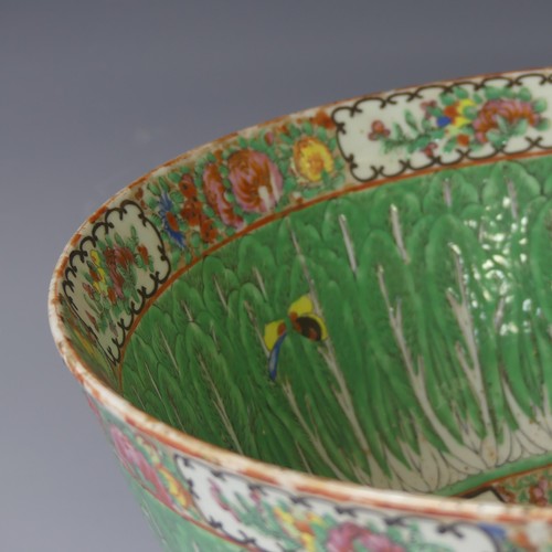 142 - A late 19thC Cantonese famille verte porcelain Punch Bowl, the rim decorated with flora and fauna in... 