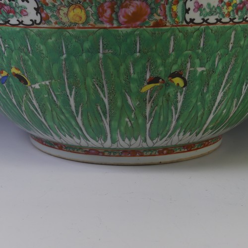 142 - A late 19thC Cantonese famille verte porcelain Punch Bowl, the rim decorated with flora and fauna in... 