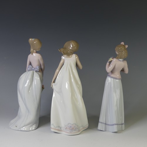 109 - A Lladro figure of 'Afternoon Promenade', together with 'Basket of Love' and 'Innocence in Bloom', a... 