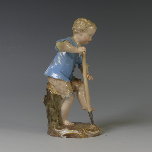 112 - A 19thC Meissen porcelain figure of a Young Gardener, the boy modelled digging with a spade, on oval... 