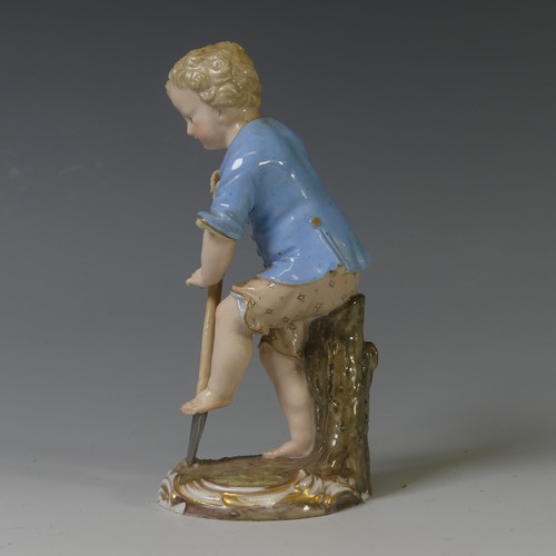 112 - A 19thC Meissen porcelain figure of a Young Gardener, the boy modelled digging with a spade, on oval... 