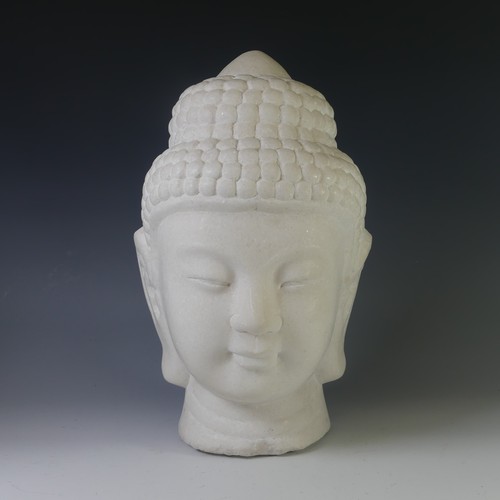 An Oriental carved stone bust of Buddha, on associated square plinth, H 42cm overall.