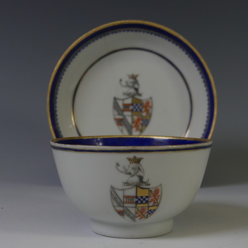 144 - An 18thC Chinese export armorial porcelain Teabowl and Saucer, decorated with gilt and blue banding ... 