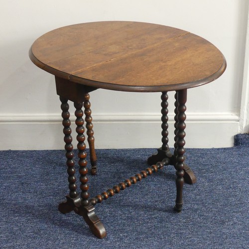 316 - A Victorian walnut 'bobbin' Sutherland Table, the oval top raised on bobbin turned supports with cas... 