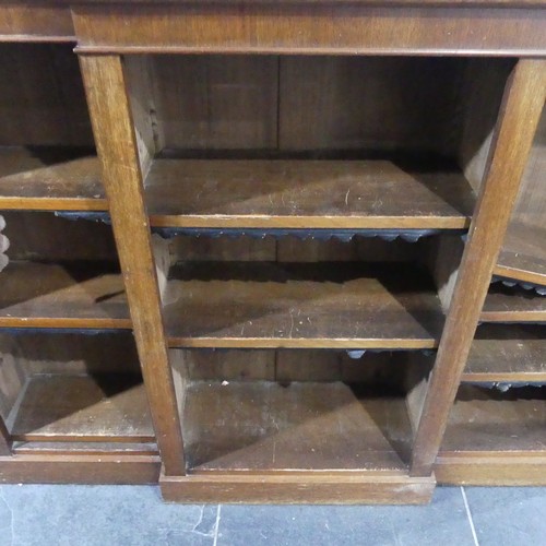 538 - A Victorian mahogany breakfront Bookcase, the open adjustable shelves with leather dust covers, all ... 