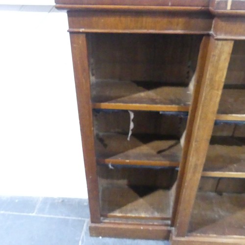 538 - A Victorian mahogany breakfront Bookcase, the open adjustable shelves with leather dust covers, all ... 