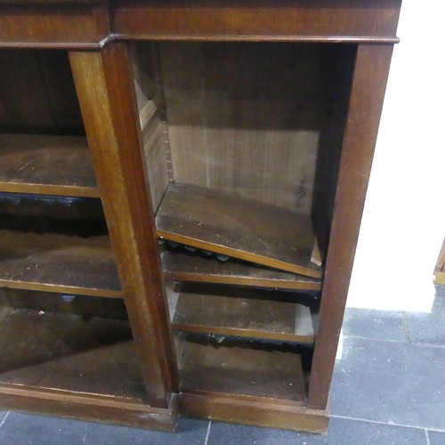 538 - A Victorian mahogany breakfront Bookcase, the open adjustable shelves with leather dust covers, all ... 