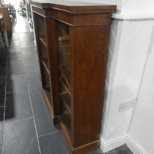 538 - A Victorian mahogany breakfront Bookcase, the open adjustable shelves with leather dust covers, all ... 