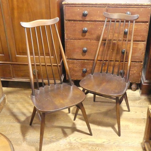 529 - A pair of vintage Ercol 'Goldsmith' Dining Chairs, having a rounded seat and stick backrest attached... 