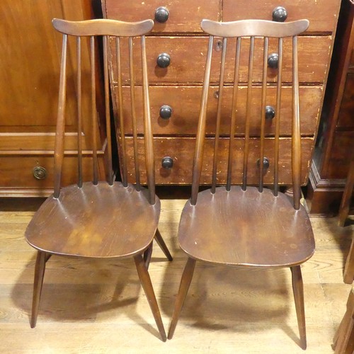 529 - A pair of vintage Ercol 'Goldsmith' Dining Chairs, having a rounded seat and stick backrest attached... 