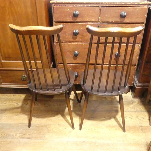 529 - A pair of vintage Ercol 'Goldsmith' Dining Chairs, having a rounded seat and stick backrest attached... 