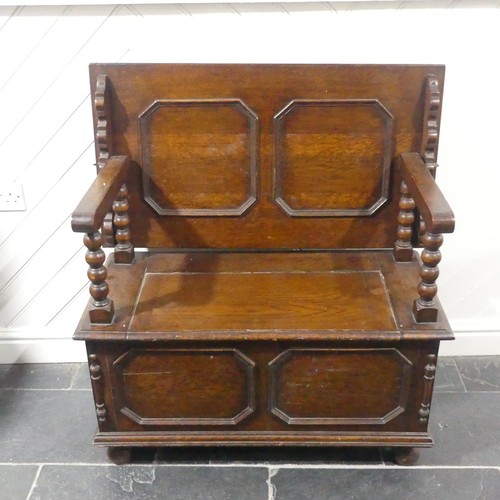 528 - A Victorian oak Monk's Bench, of typical box form, the sliding top raised on turned column supports,... 