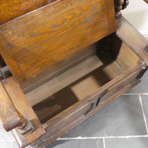 528 - A Victorian oak Monk's Bench, of typical box form, the sliding top raised on turned column supports,... 