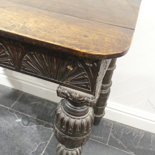 539 - A Victorian oak Console Table, the D shaped top upon a carved frieze, raised on carved and turned le... 